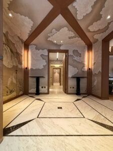 Luxury bathroom and entrance hall featuring bespoke Rosaline marble and Travertine stone cladding.